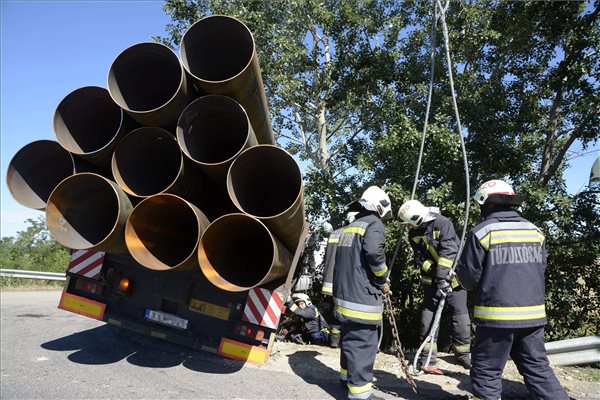 A katasztrófavédelem darujával emelnek egy kamiont, miután a 4-es útról lekanyarodó jármű hátsó kerekei az árokba csúsztak  Szajol közelében 2014. július 10-én.  A balesetben senki nem sérült meg. MTI Fotó: Mészáros János