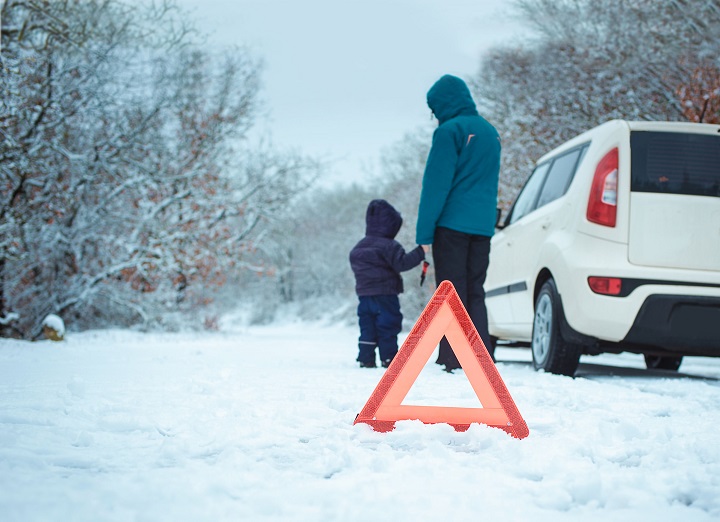 36813055 - woman with a child on the winter road. emergency sign